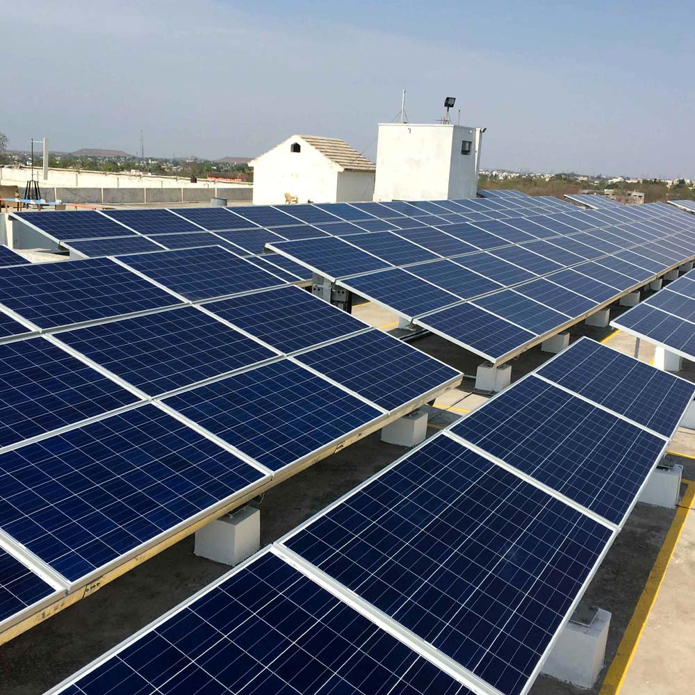 Solar panels with power plant in background